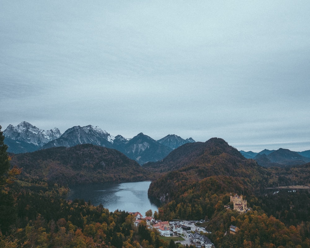 a scenic view of a lake surrounded by mountains