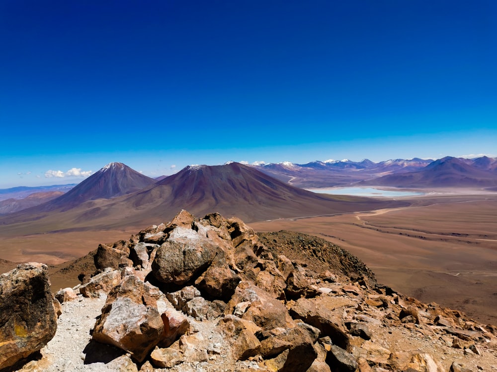 a view of a mountain range from a rocky outcropping