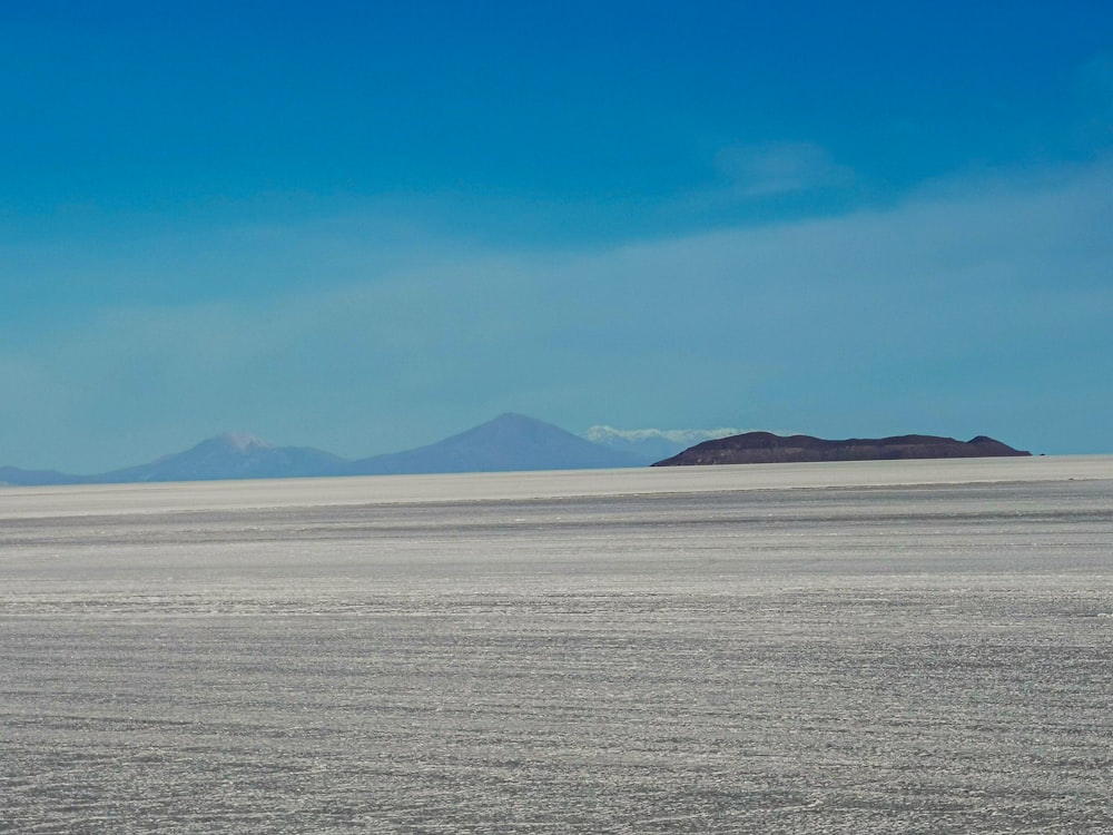 a large open plain with mountains in the distance