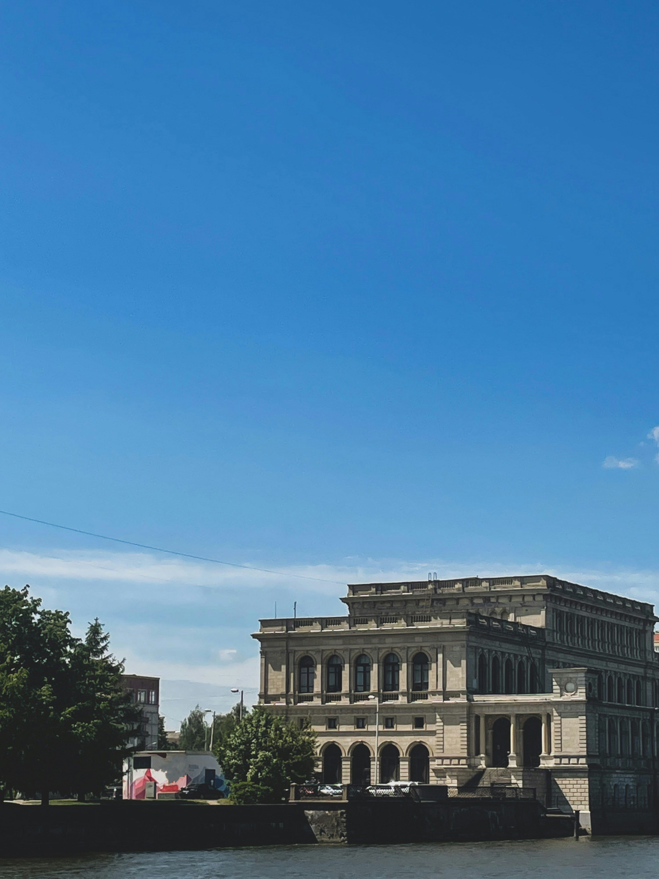 a large building sitting on the side of a river