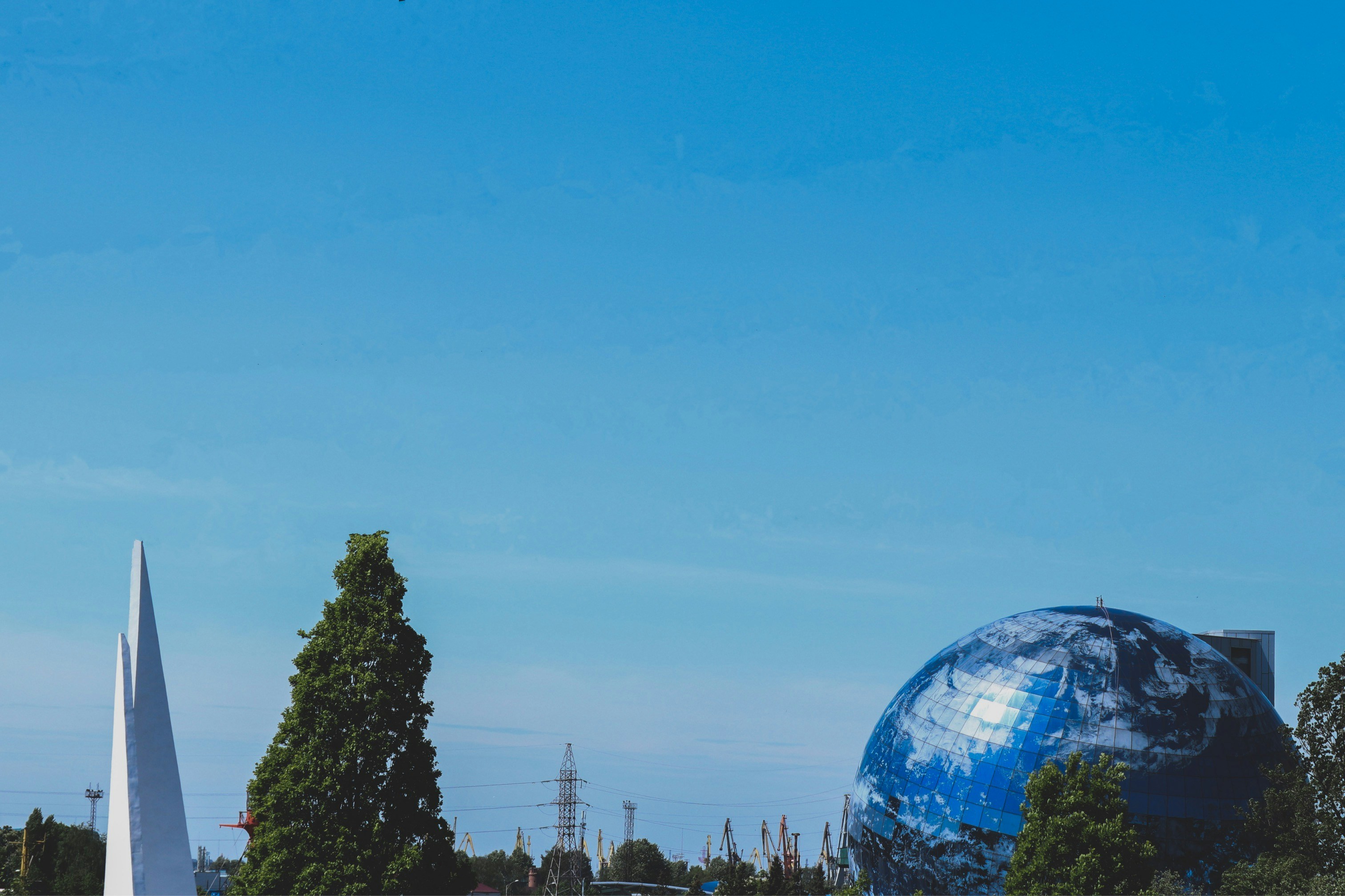 a large blue globe sitting in the middle of a park