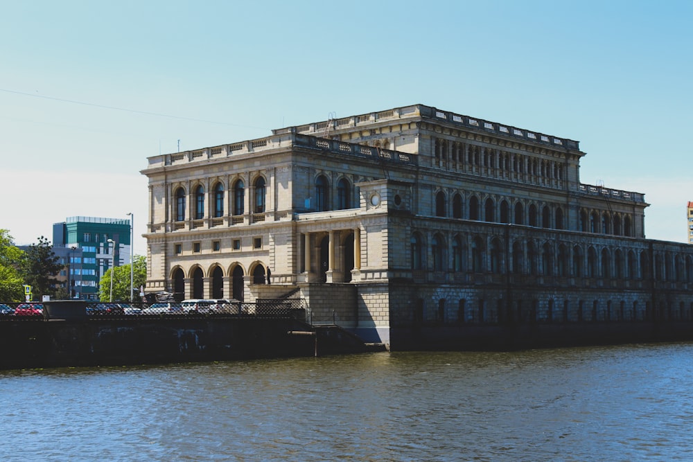 a large building sitting on the side of a river