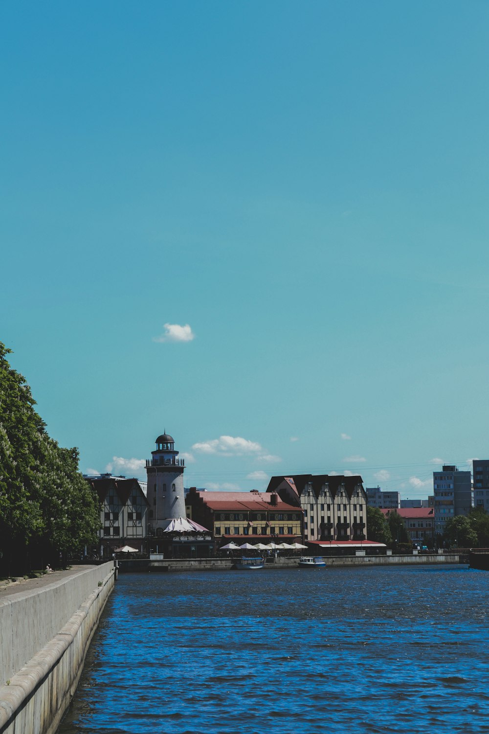 a body of water with a light house in the background