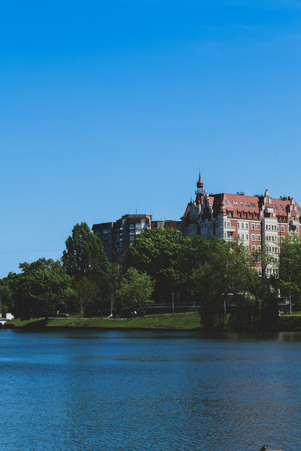 a large body of water with a building in the background