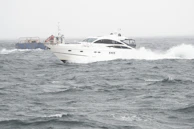 An adventurous sailor adjusting sails on a dynamic racing yacht in choppy seas.