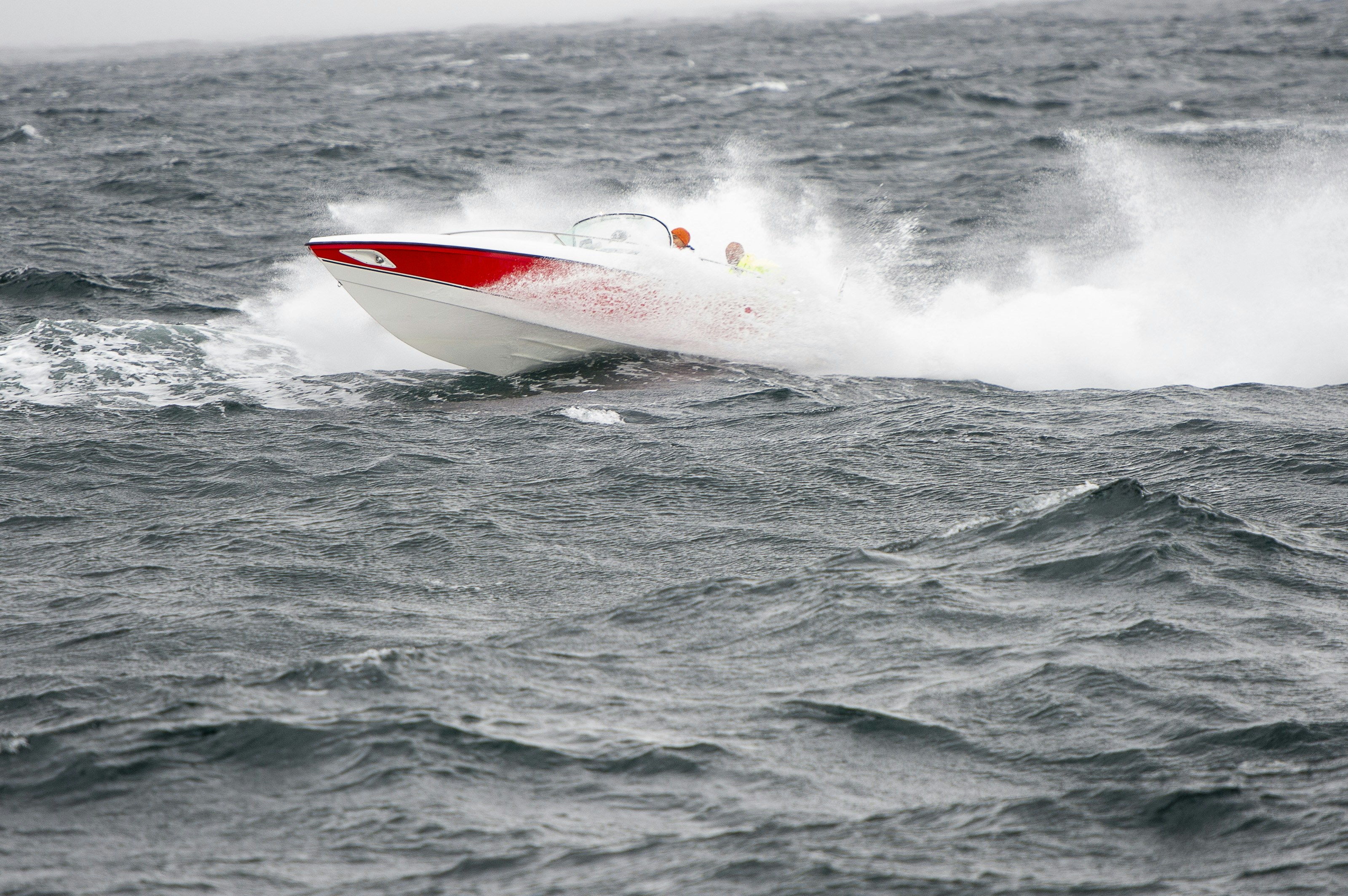 A red and white boat in the middle of the ocean photo – Free Grey Image ...