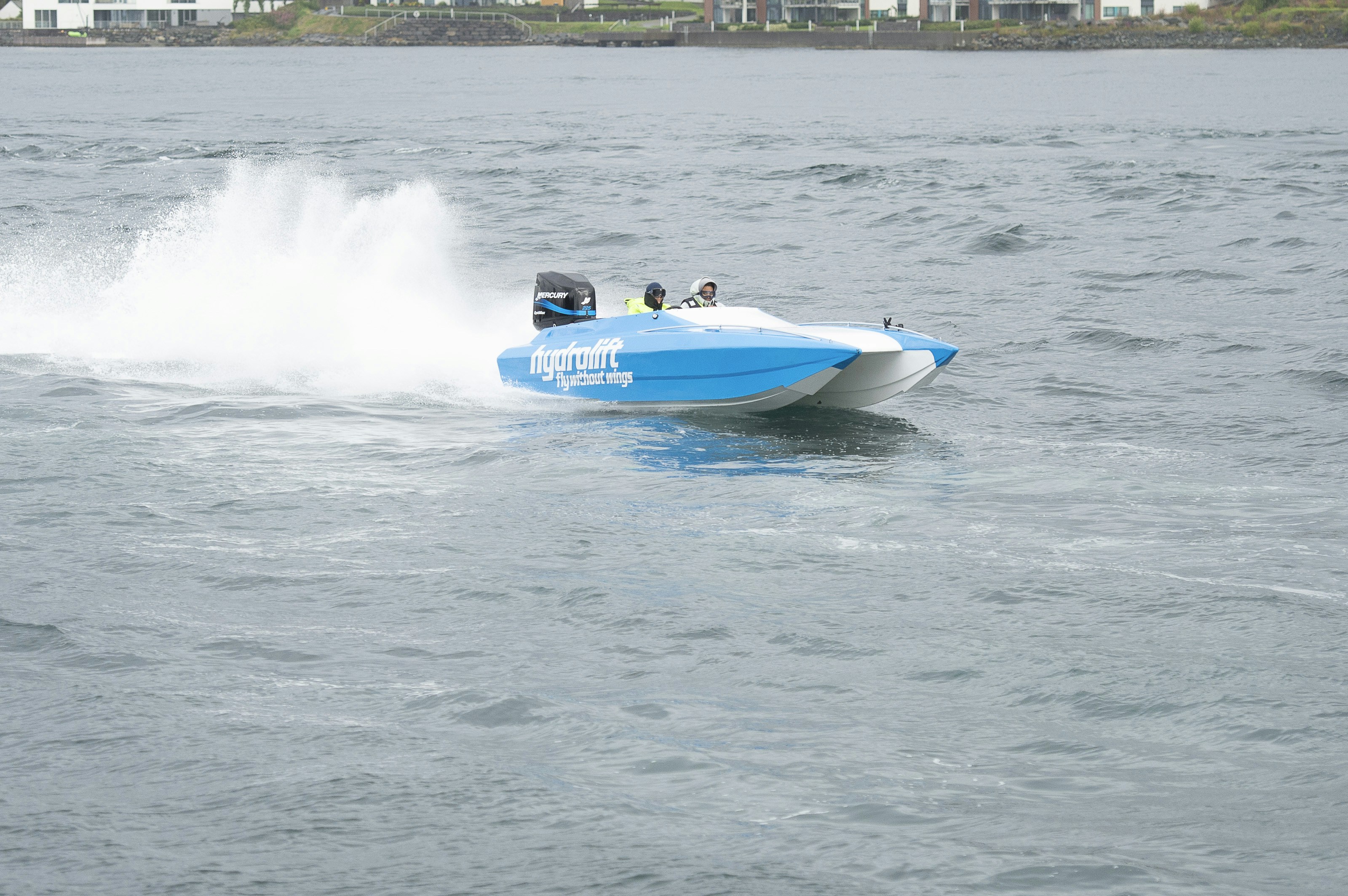 a blue and white speed boat in the water