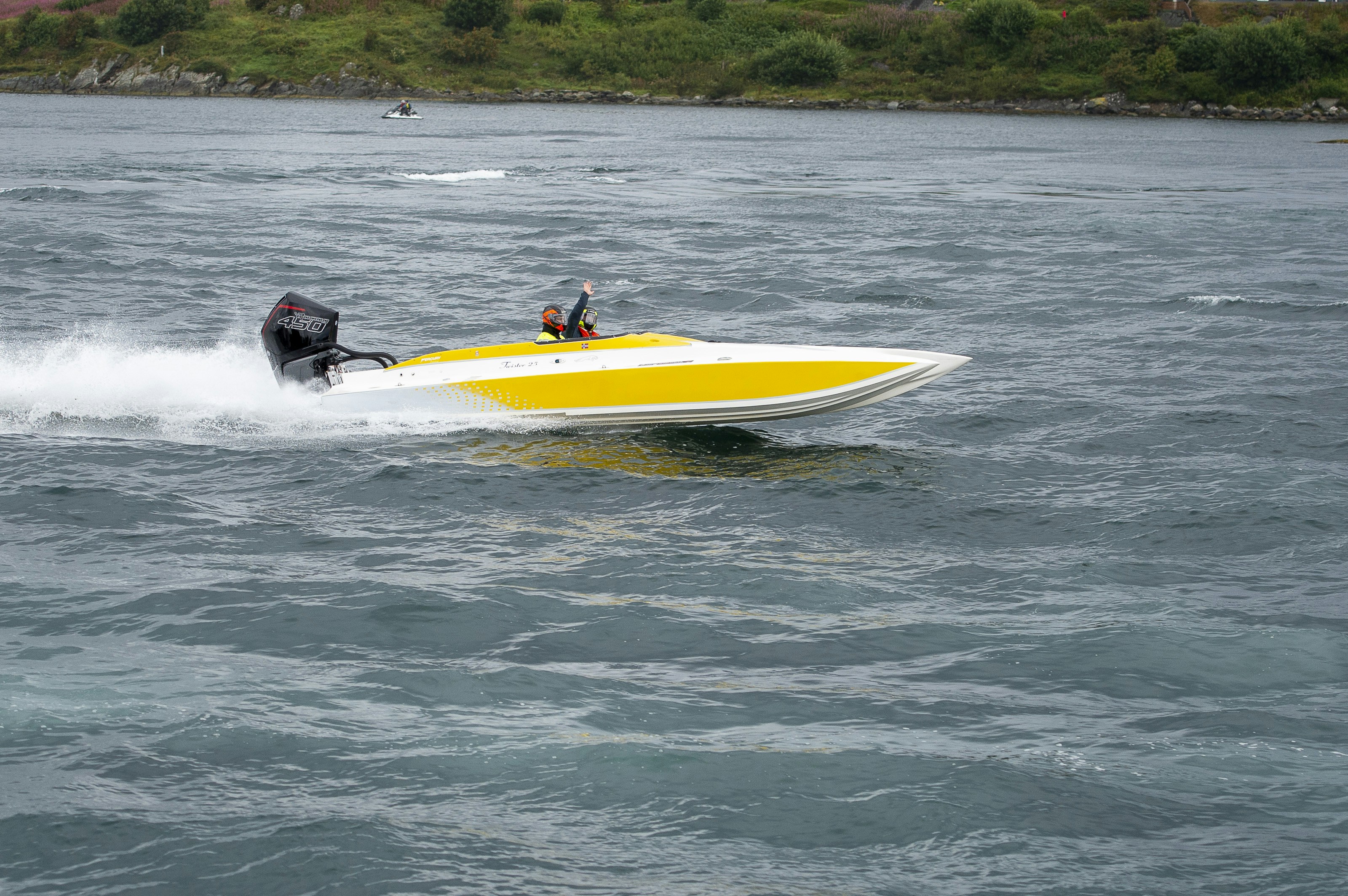 a yellow and white speed boat in the water