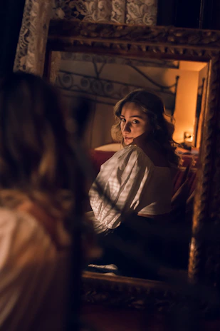 A warm, inviting portrait of a confident woman embracing change with a stylish outfit in a softly lit room