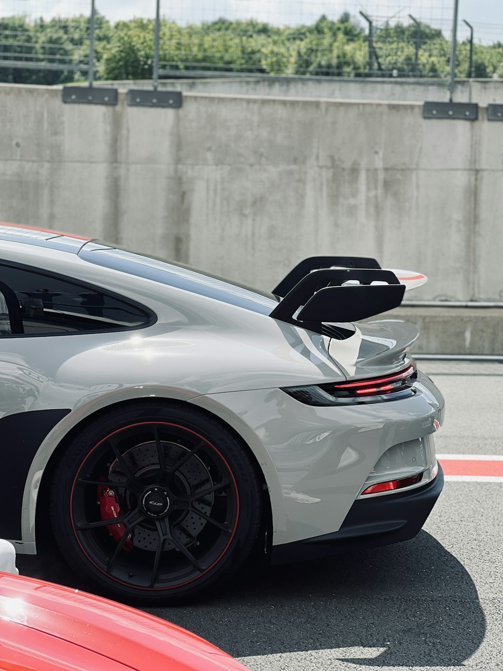 a white and black sports car parked on a race track