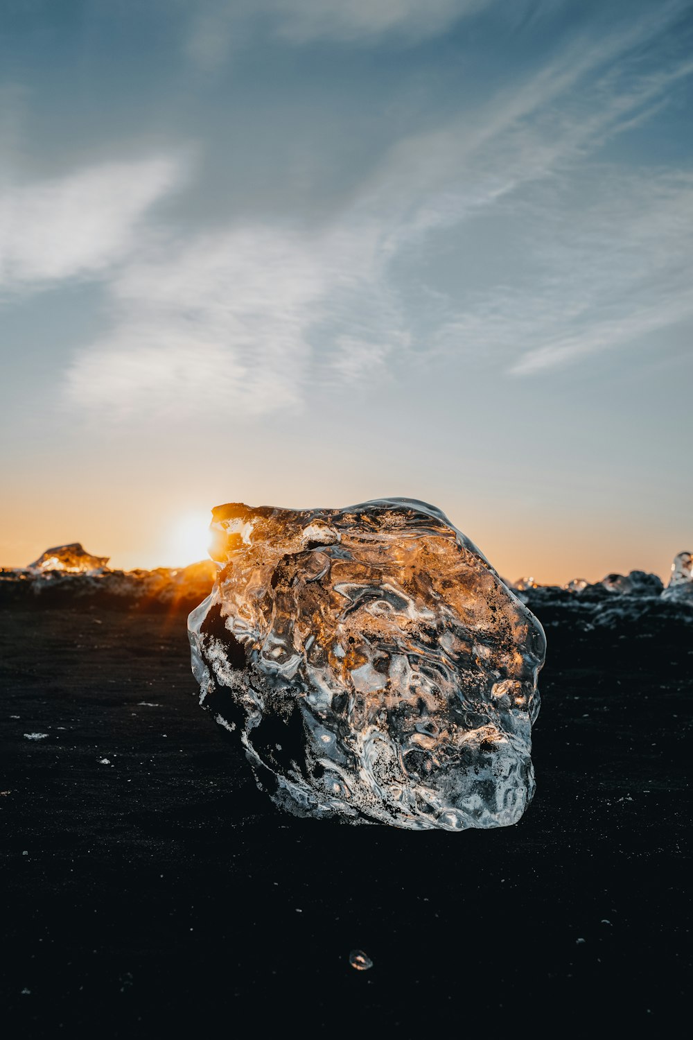 a large ice block sitting on top of a beach