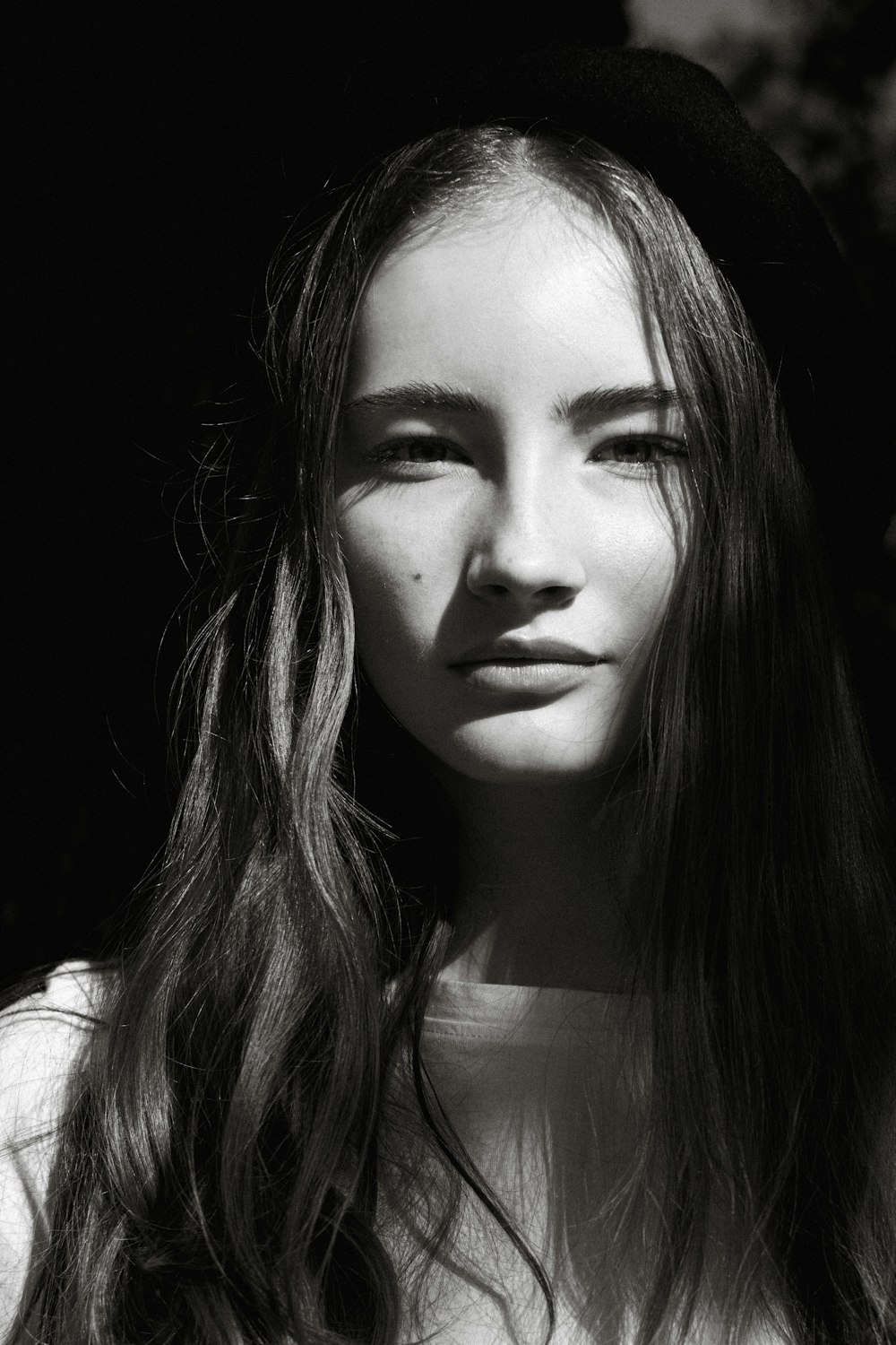 a black and white photo of a woman with long hair