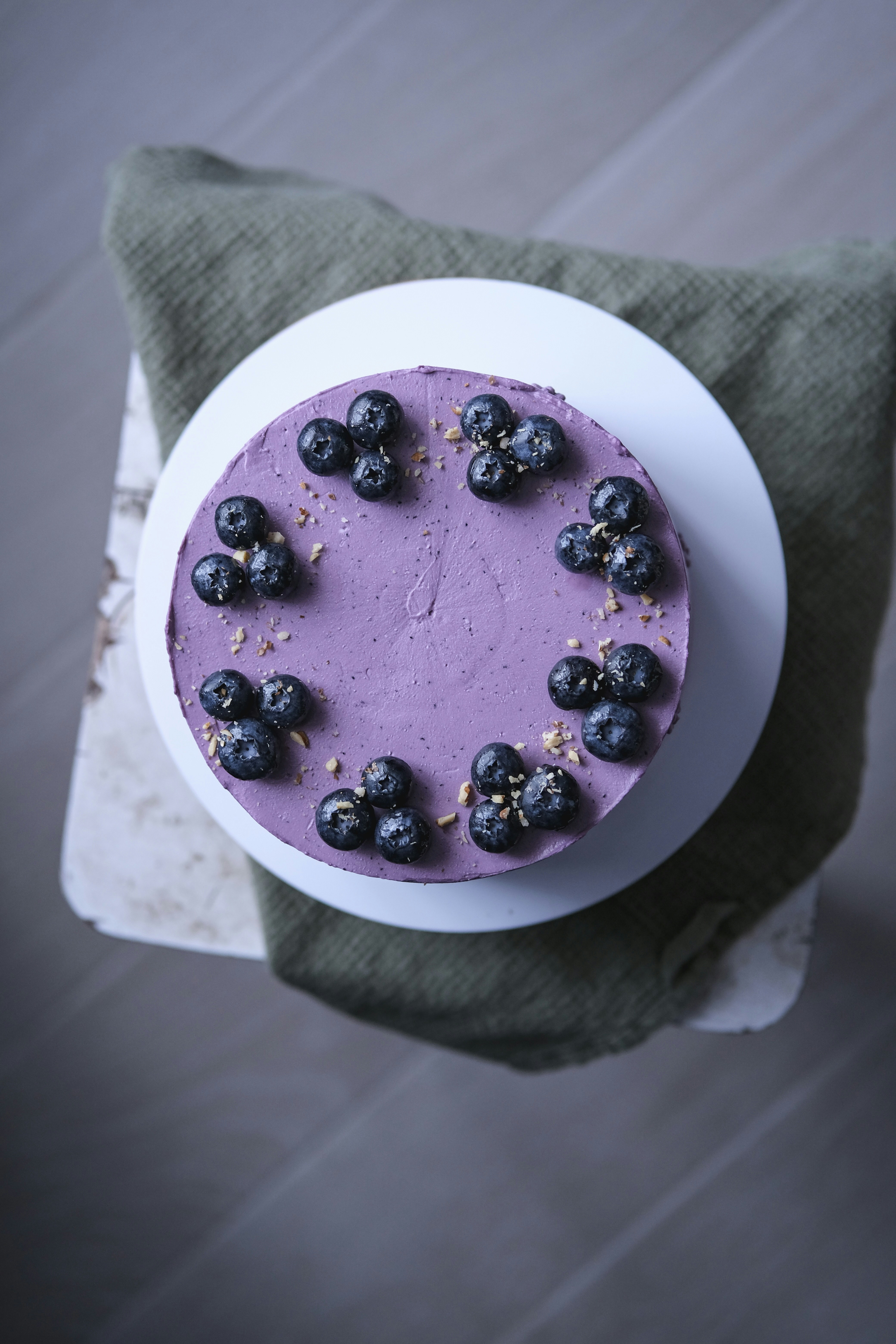 a cake with blueberries on top of a white plate