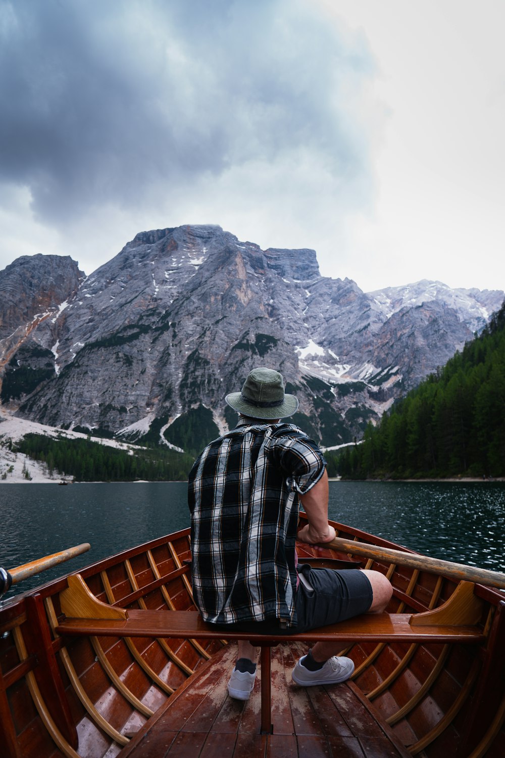 a man sitting in a boat on top of a lake