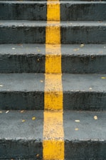 a set of stairs with a yellow line painted on it