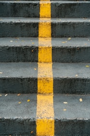 a set of stairs with a yellow line painted on it