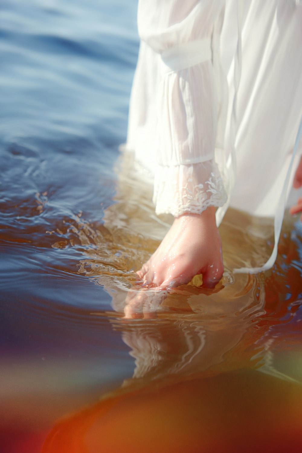 a person standing in the water with their feet in the water