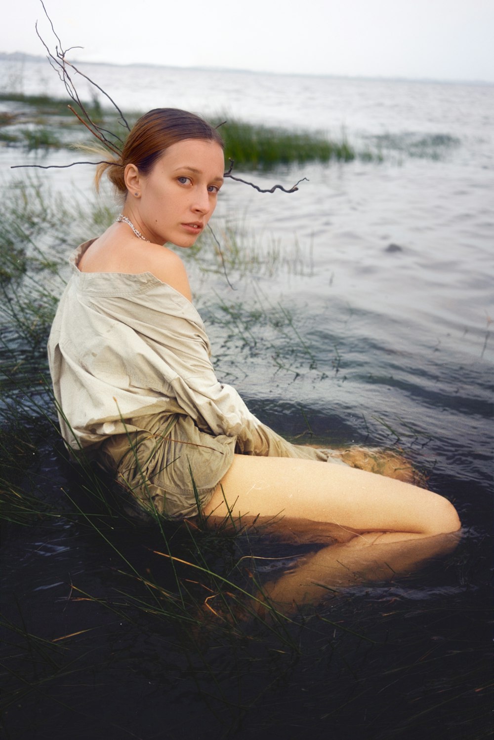 a woman sitting in a body of water