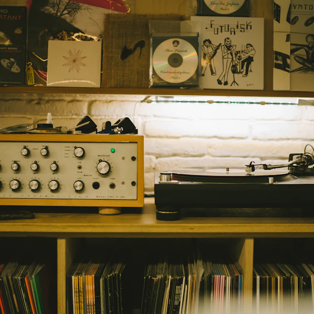 A record player sitting on top of a wooden table