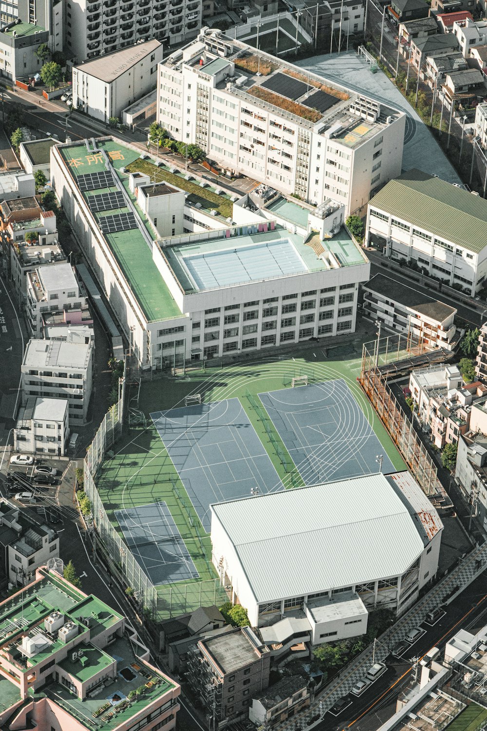 an aerial view of a tennis court in a city