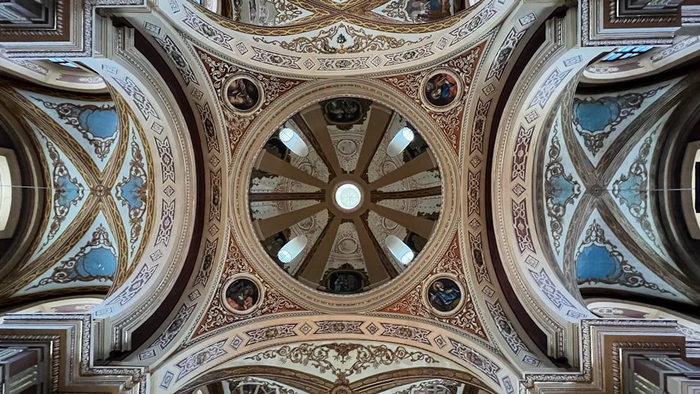 the ceiling of a building with a circular window