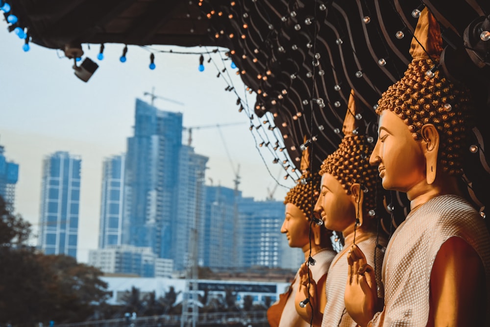 a row of buddha statues sitting next to each other