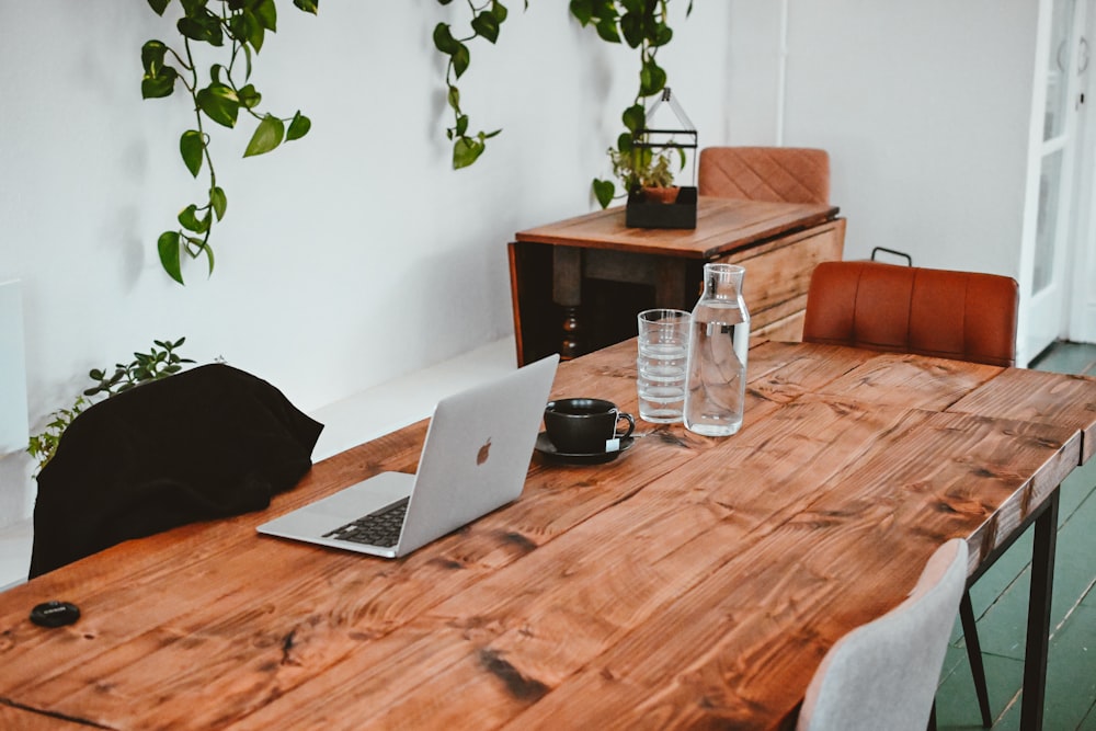 a wooden table topped with a laptop computer