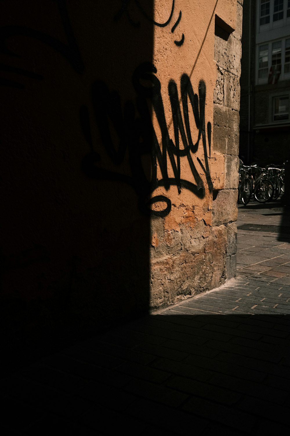 a shadow of a person walking down a street