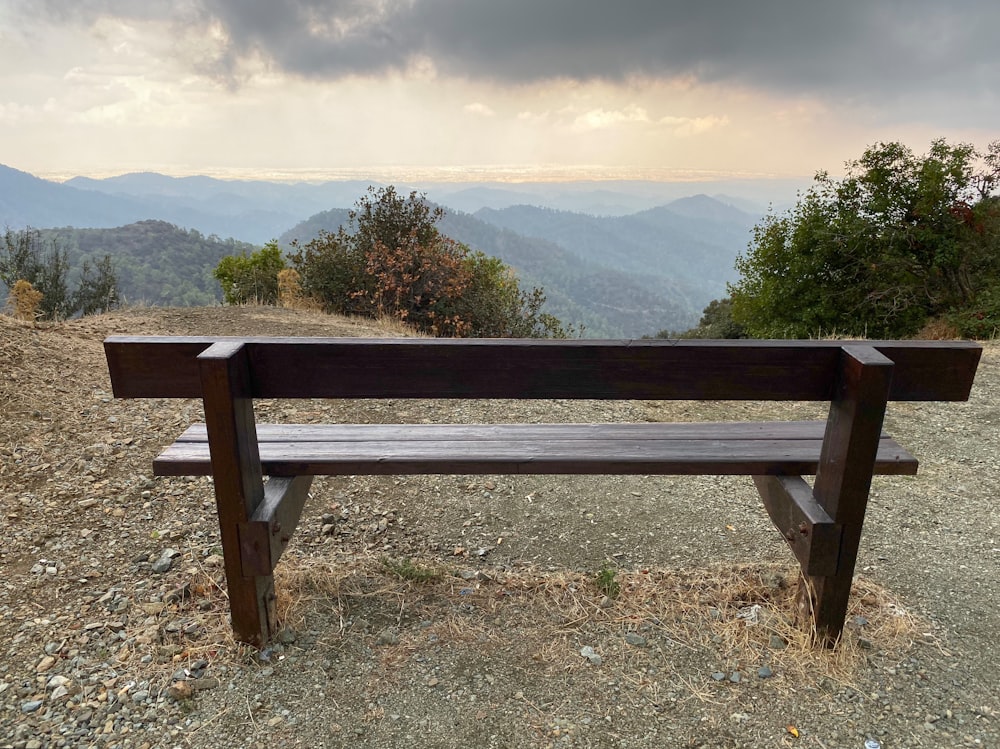 a wooden bench sitting on top of a hill