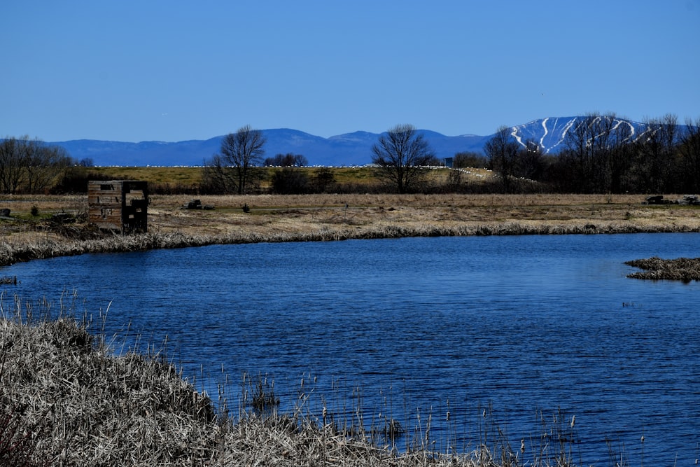 a body of water with mountains in the background