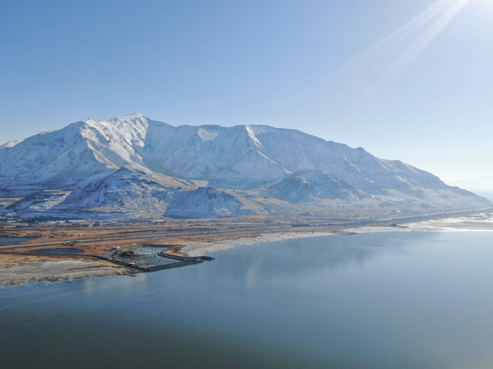 a large body of water with a mountain in the background