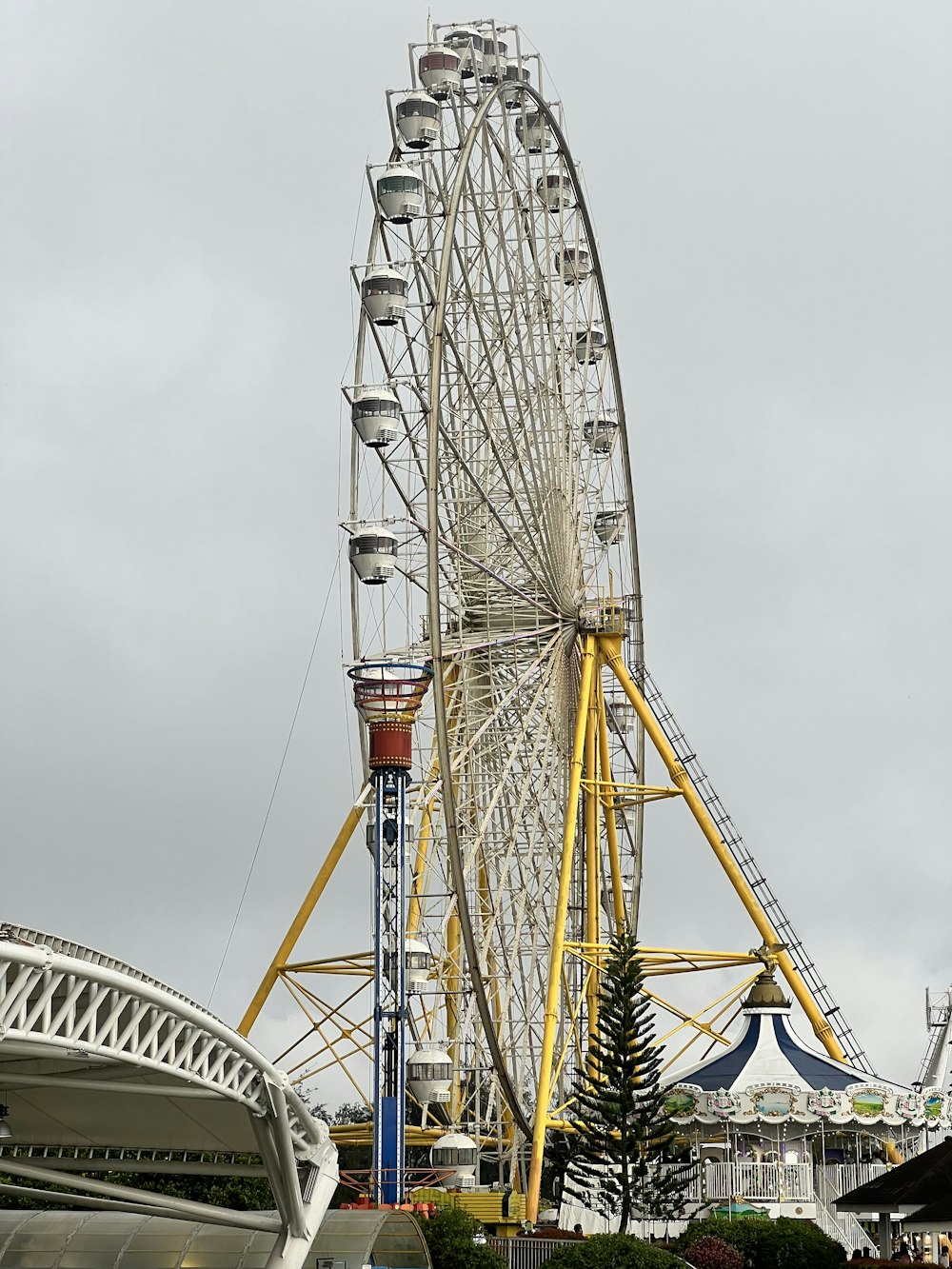a large ferris wheel sitting next to a tall building