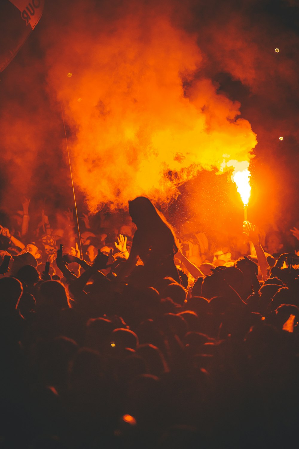 a crowd of people standing around a fire