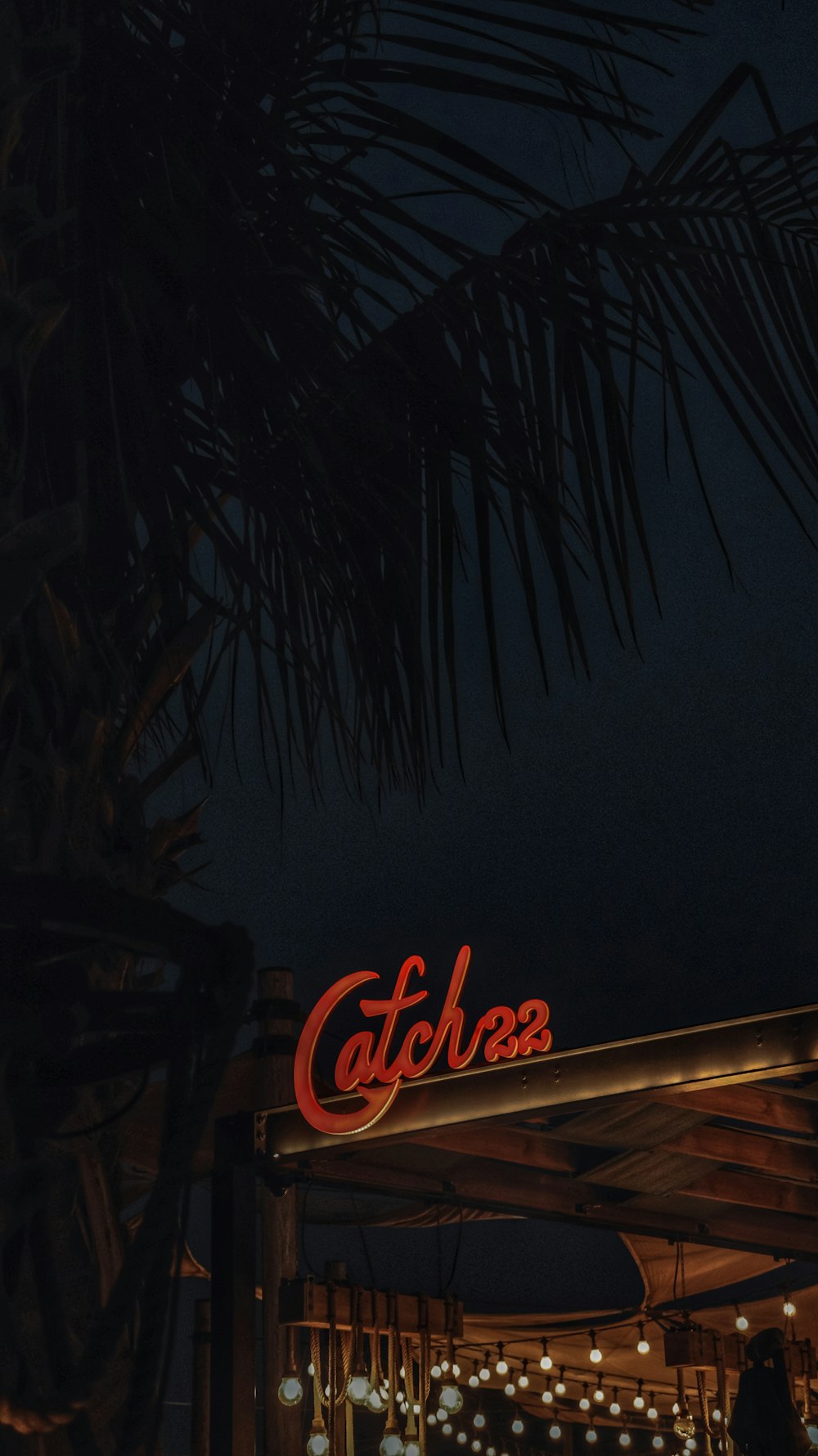 a restaurant with a lit up sign at night