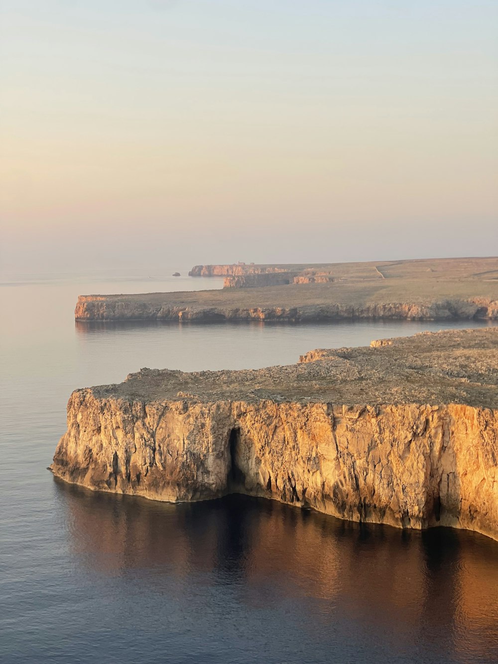 a large body of water surrounded by rocky cliffs