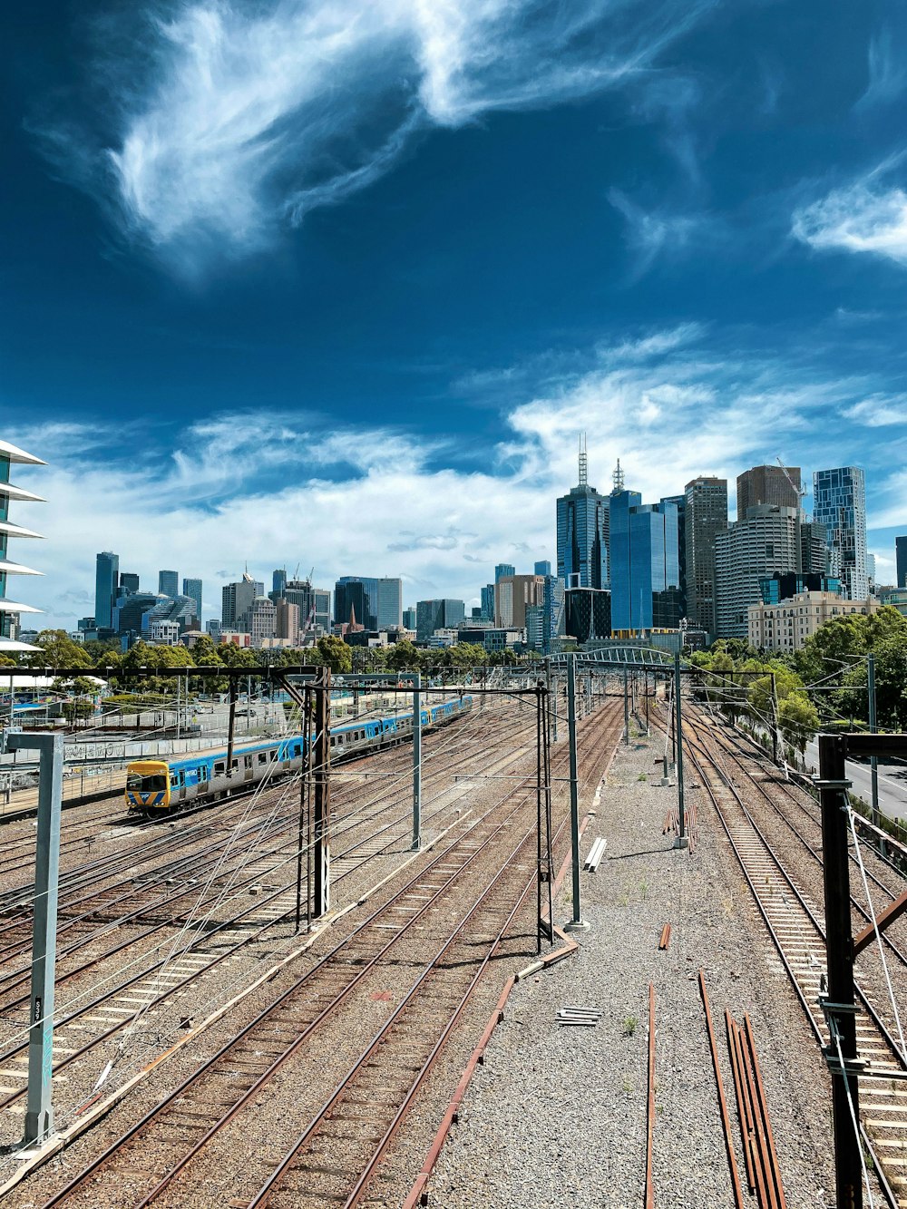 a view of a train station with a city in the background