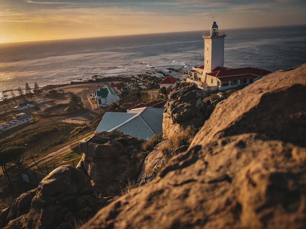 a lighthouse on top of a cliff near the ocean