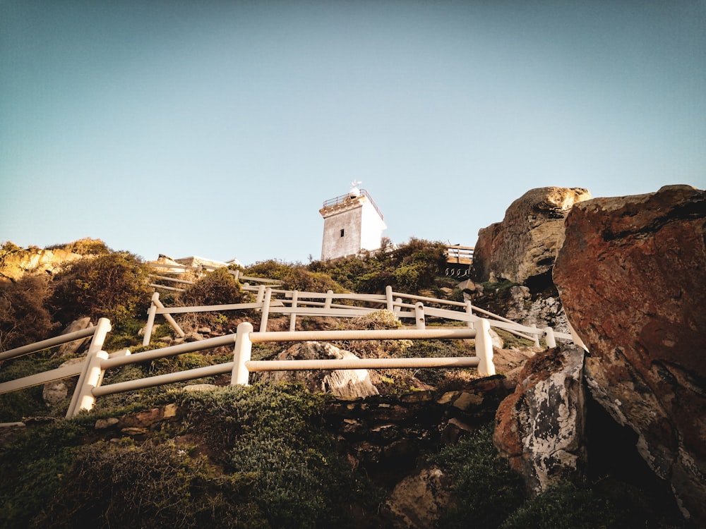 a white lighthouse on top of a hill