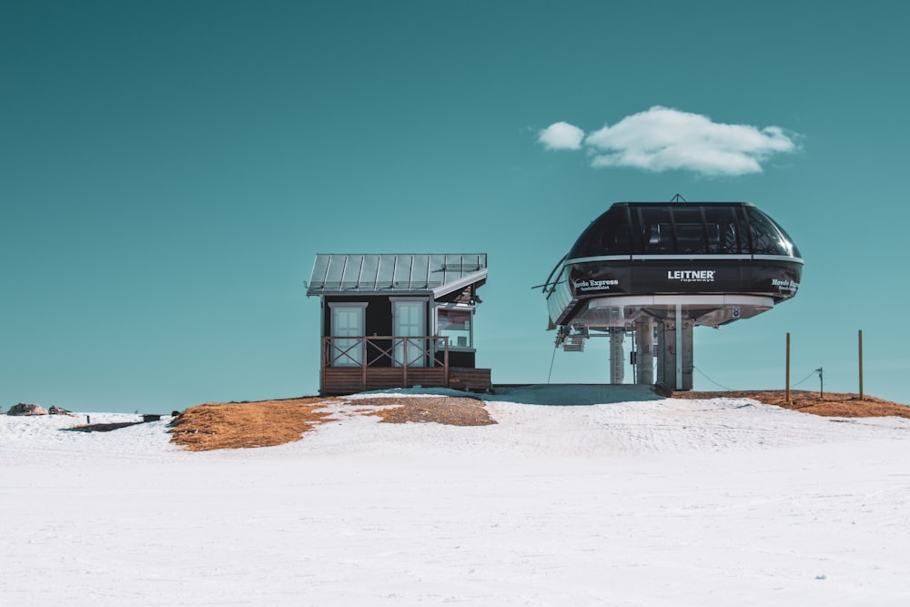 a couple of buildings sitting on top of a snow covered hill