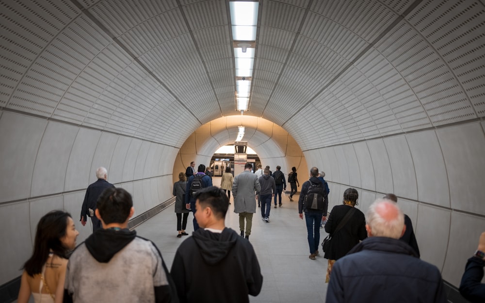 a group of people walking through a tunnel