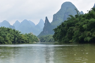 A serene landscape of the Li River with karst mountains.