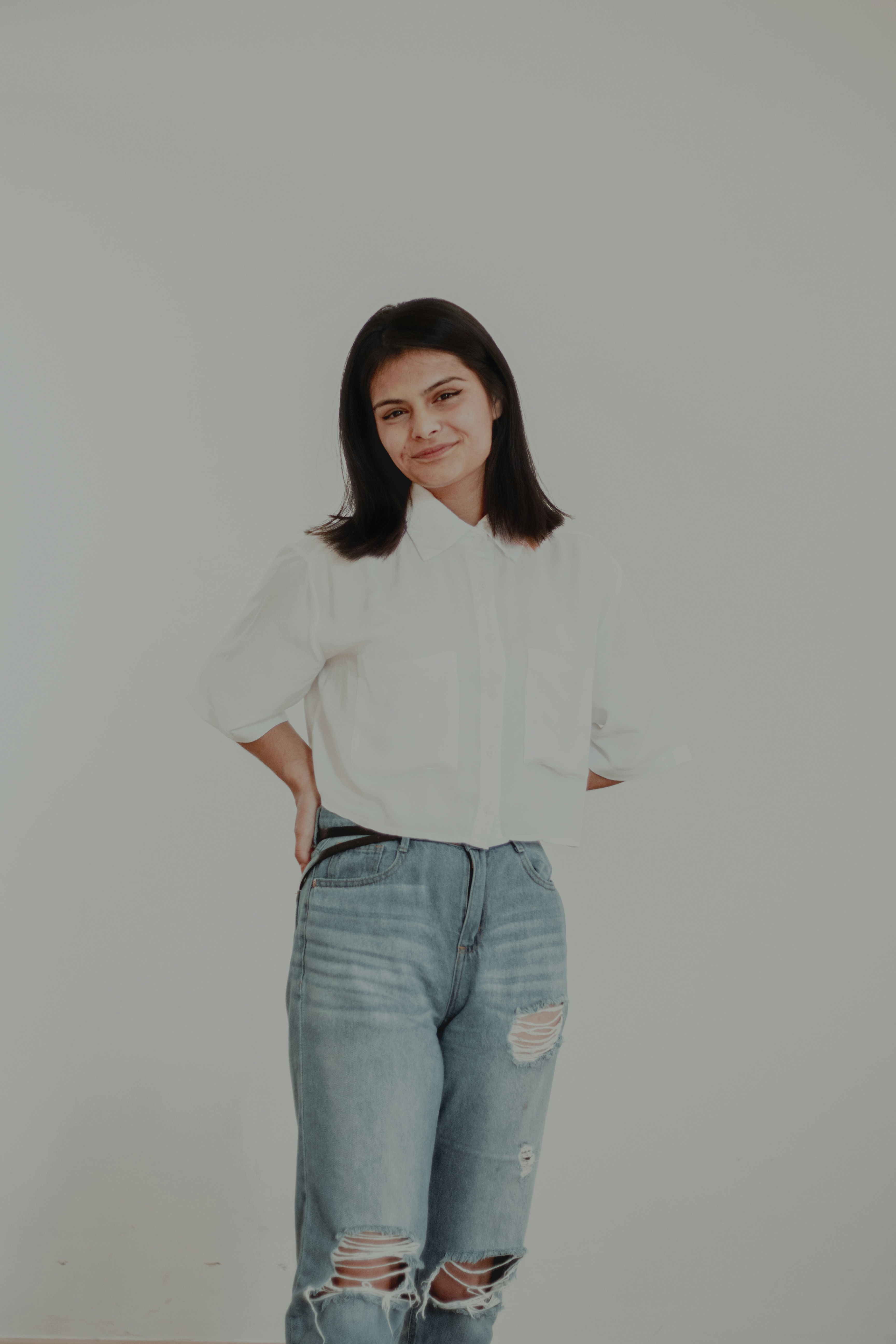 A woman standing with her hands on her hips photo – Free Clothing Image ...