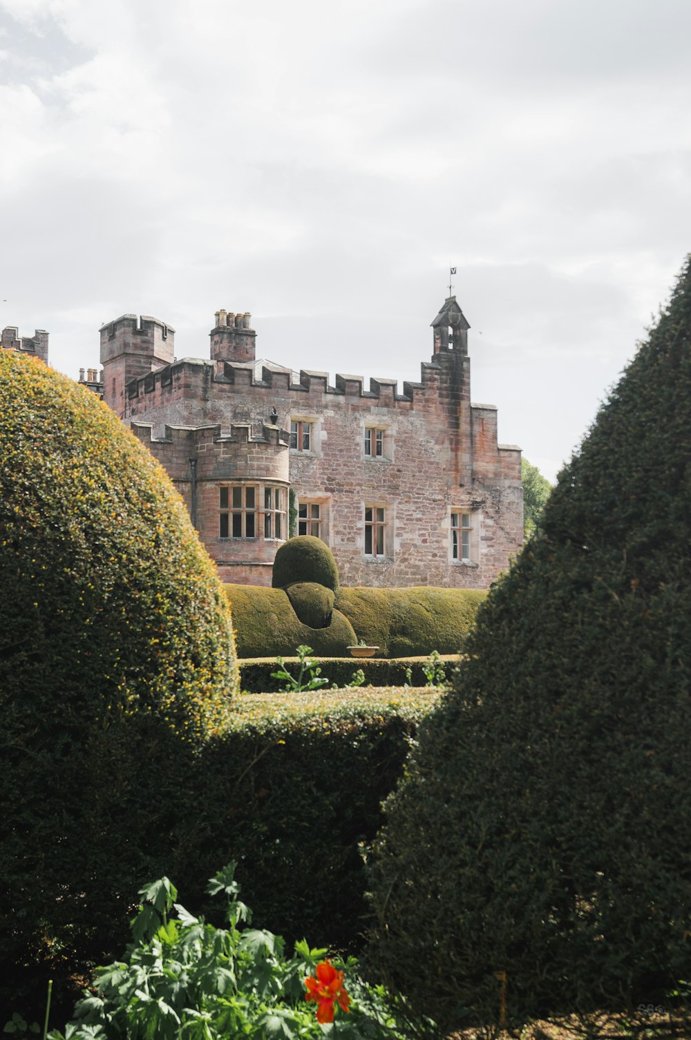 a castle with a garden in front of it