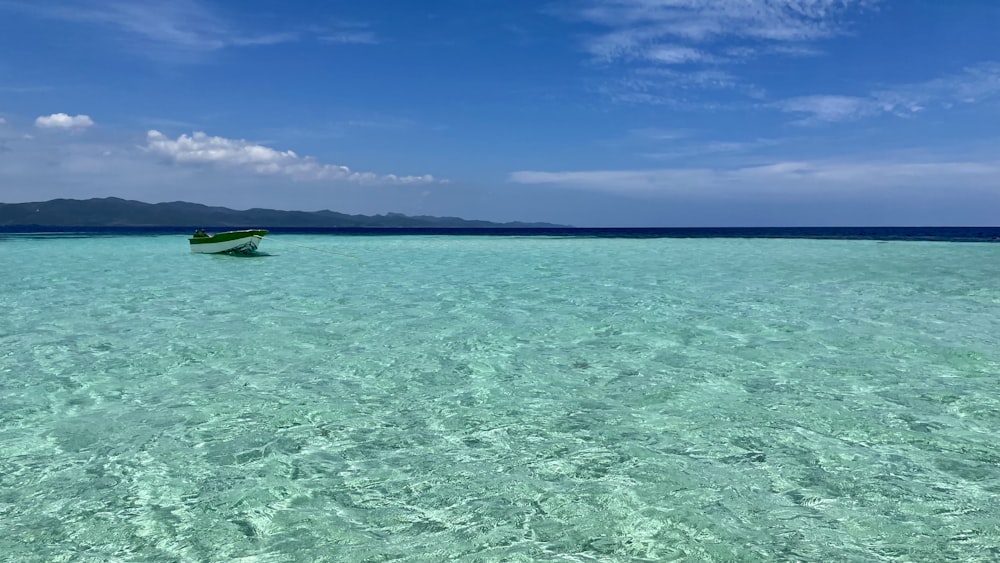 a small boat floating on top of a body of water