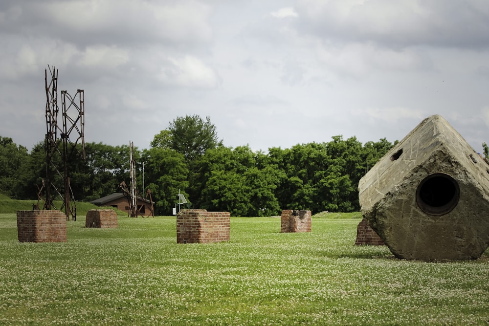 a large rock sitting in the middle of a field