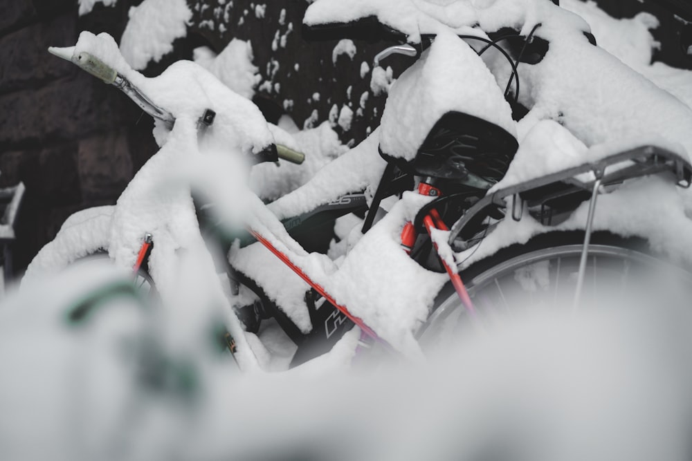a bicycle covered in snow next to a building