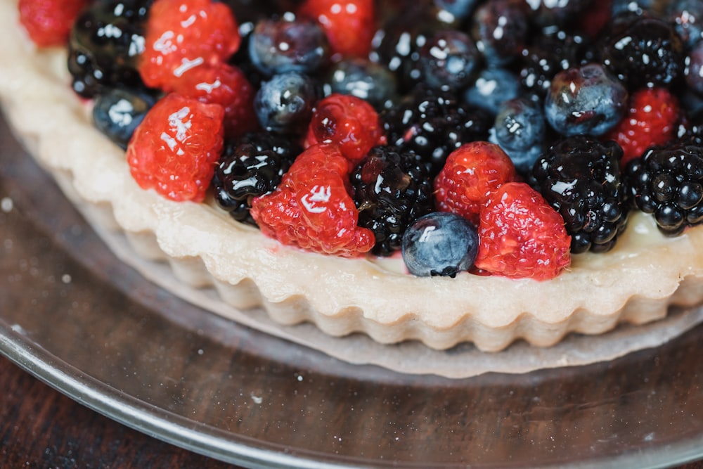 a pie with berries and blueberries on top of it