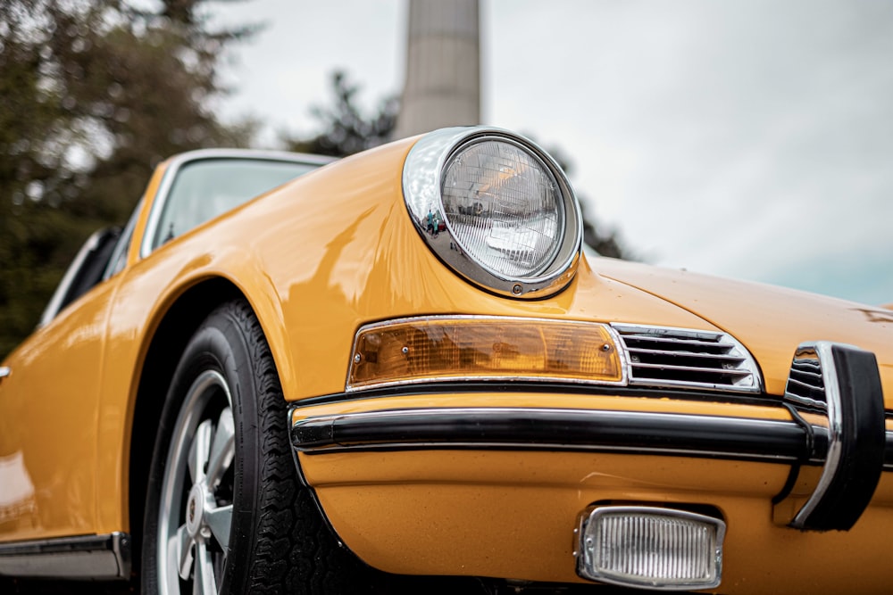 a close up of a yellow sports car