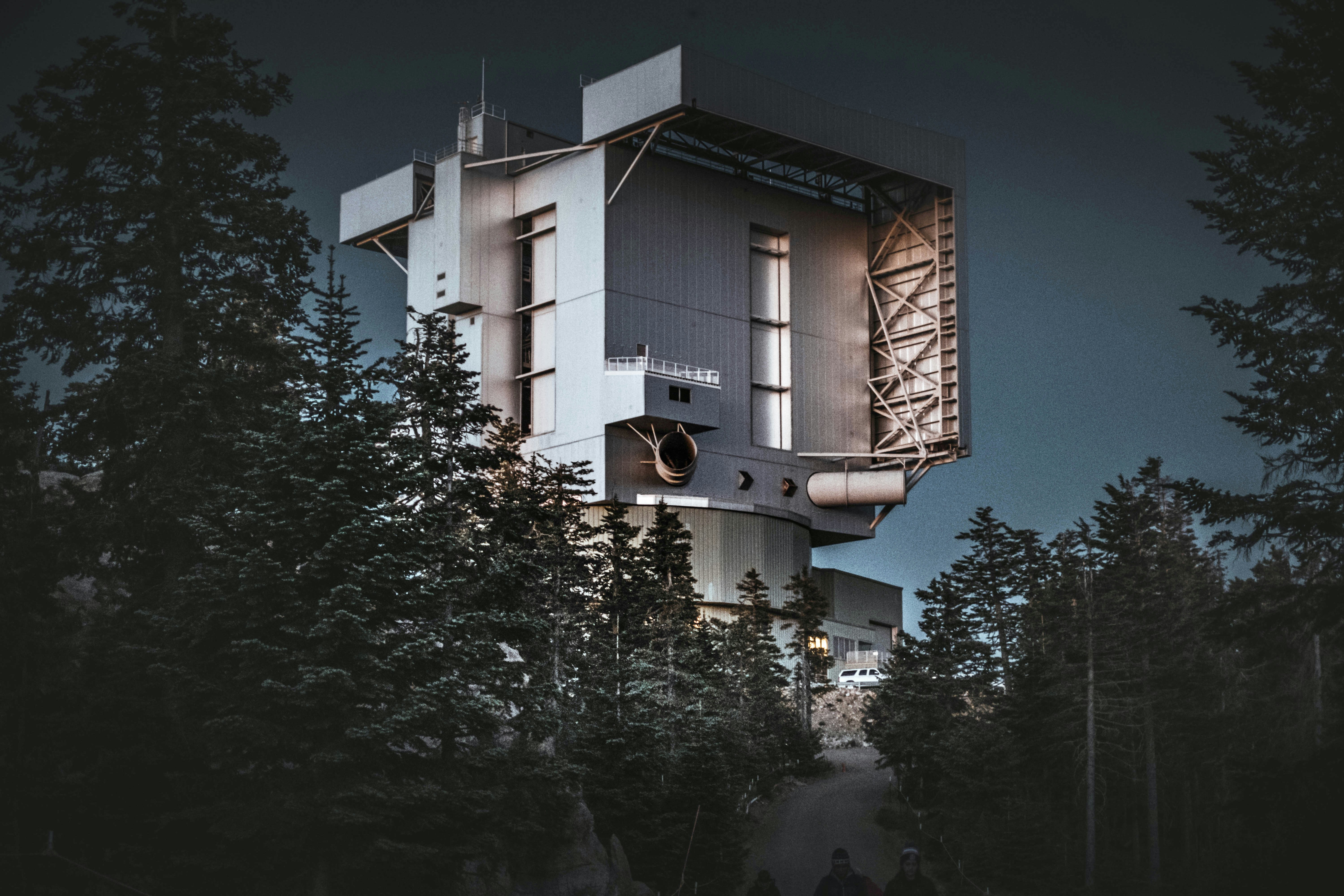 a very tall building sitting in the middle of a forest