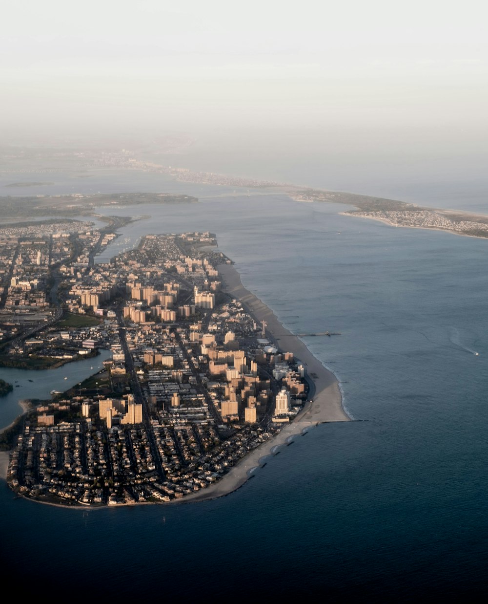 an aerial view of a city and a body of water